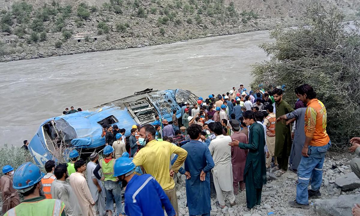 Local residents and rescue workers gather at the site of bus accident, in Kohistan Kohistan district of Pakistan’s Khyber Pakhtunkhwa province, Wednesday, July 14, 2021. A bus carrying Chinese and Pakistani construction workers on a slippery mountainous road in northwest Pakistan fell into a ravine Wednesday, killing a dozen of people, including Chinese nationals, and dozens were injured, a government official said
