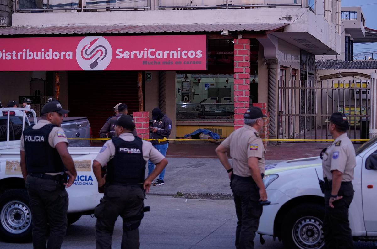 Police work the scene as the body of slain football player Mario Pineida lies on the floor at a butcher shop in Guayaquil, Ecuador, Wednesday, Dec. 17, 2025. Police work the scene as the body of slain football player Mario Pineida lies on the floor at a butcher shop in Guayaquil, Ecuador, Wednesday, Dec. 17, 2025.