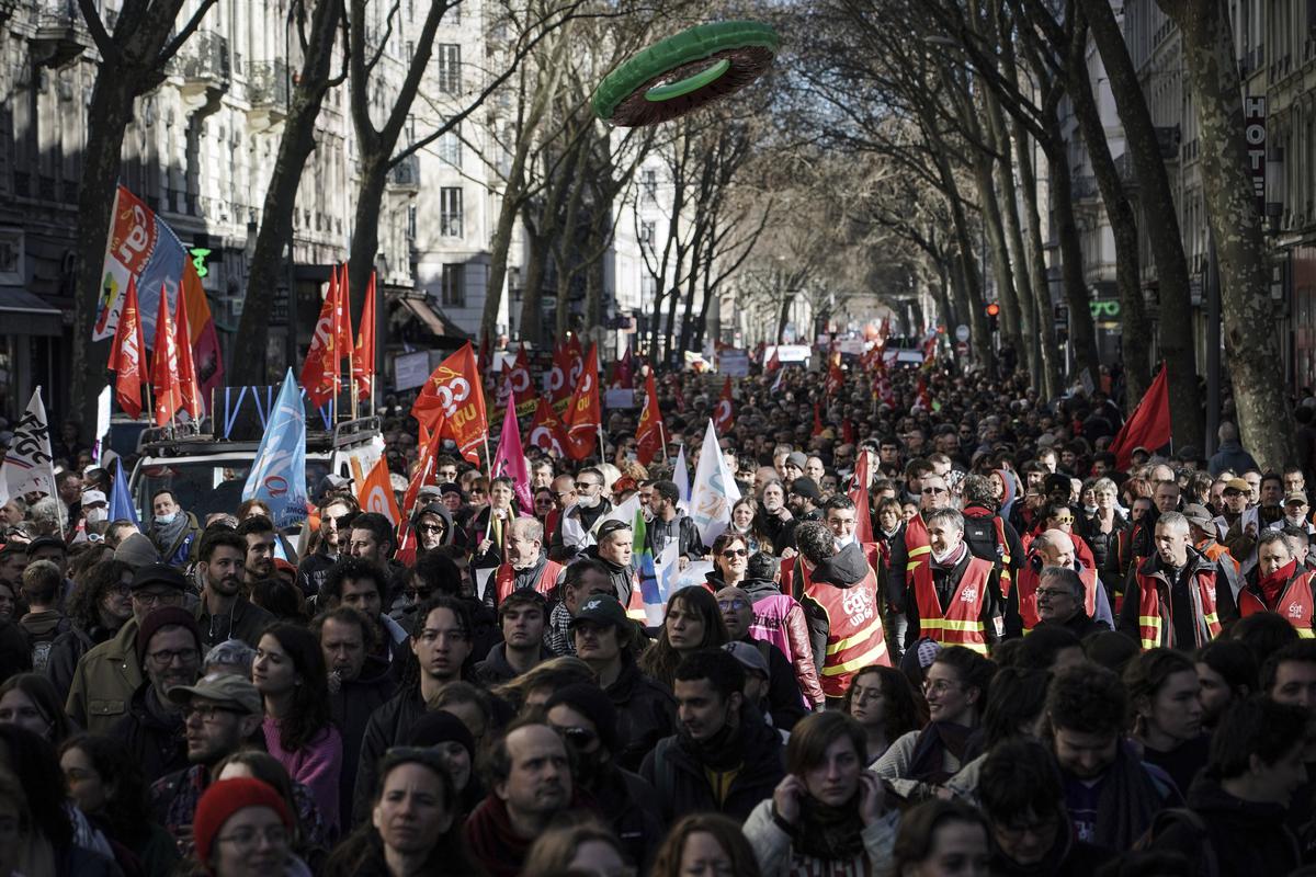 Protesters walk during a demonstration in Lyon, central France, Wednesday, March 15, 2023.  