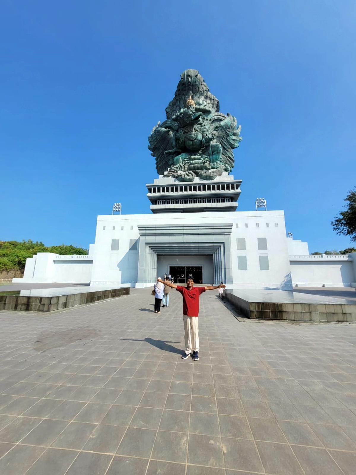 Kavirajan P.K. in front of Garuda Wisnu Kencana statue in Indonesia.