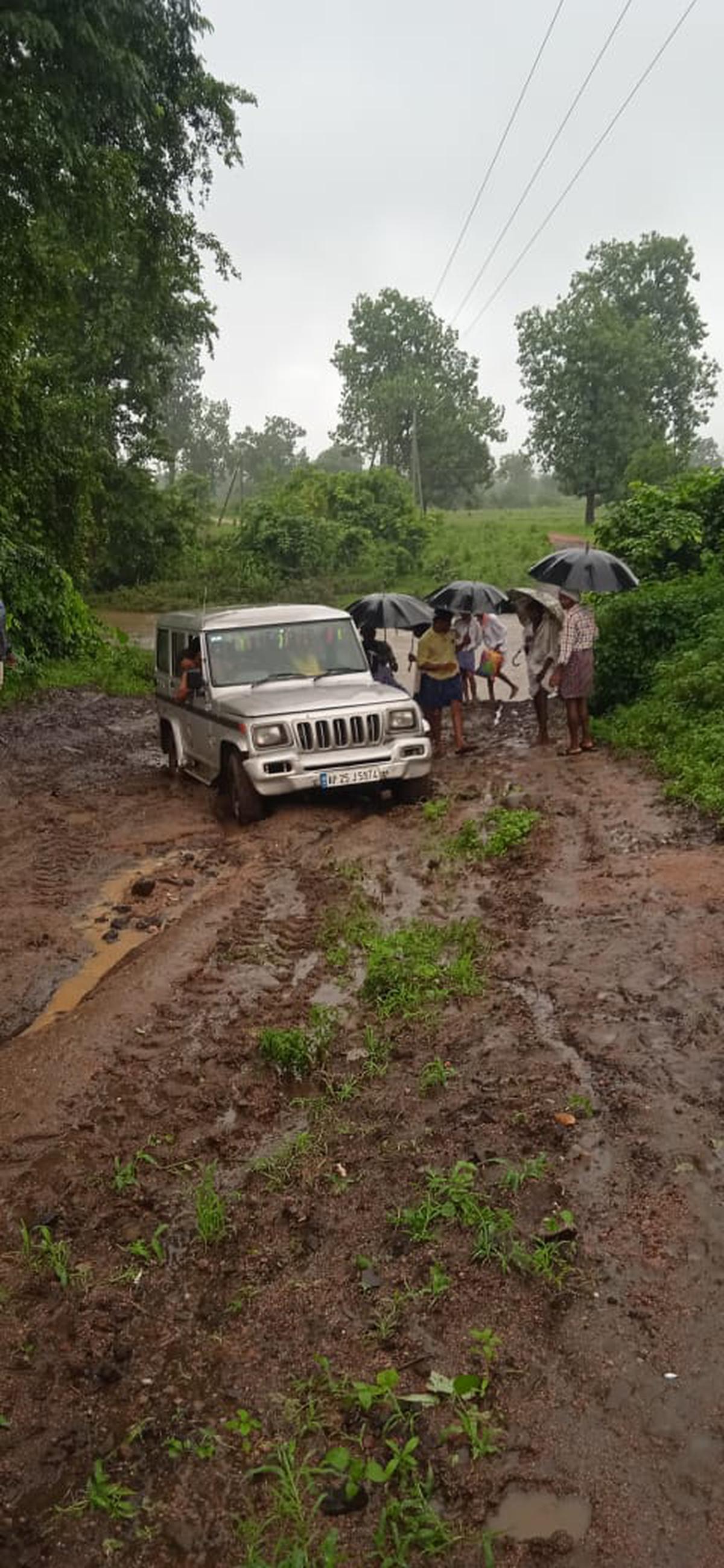 A health team escorts a pregnant woman from Narsapur J village to a safe place in a four wheeler after roadways are cut off due to an overflow.  Photo: Special Arrangements