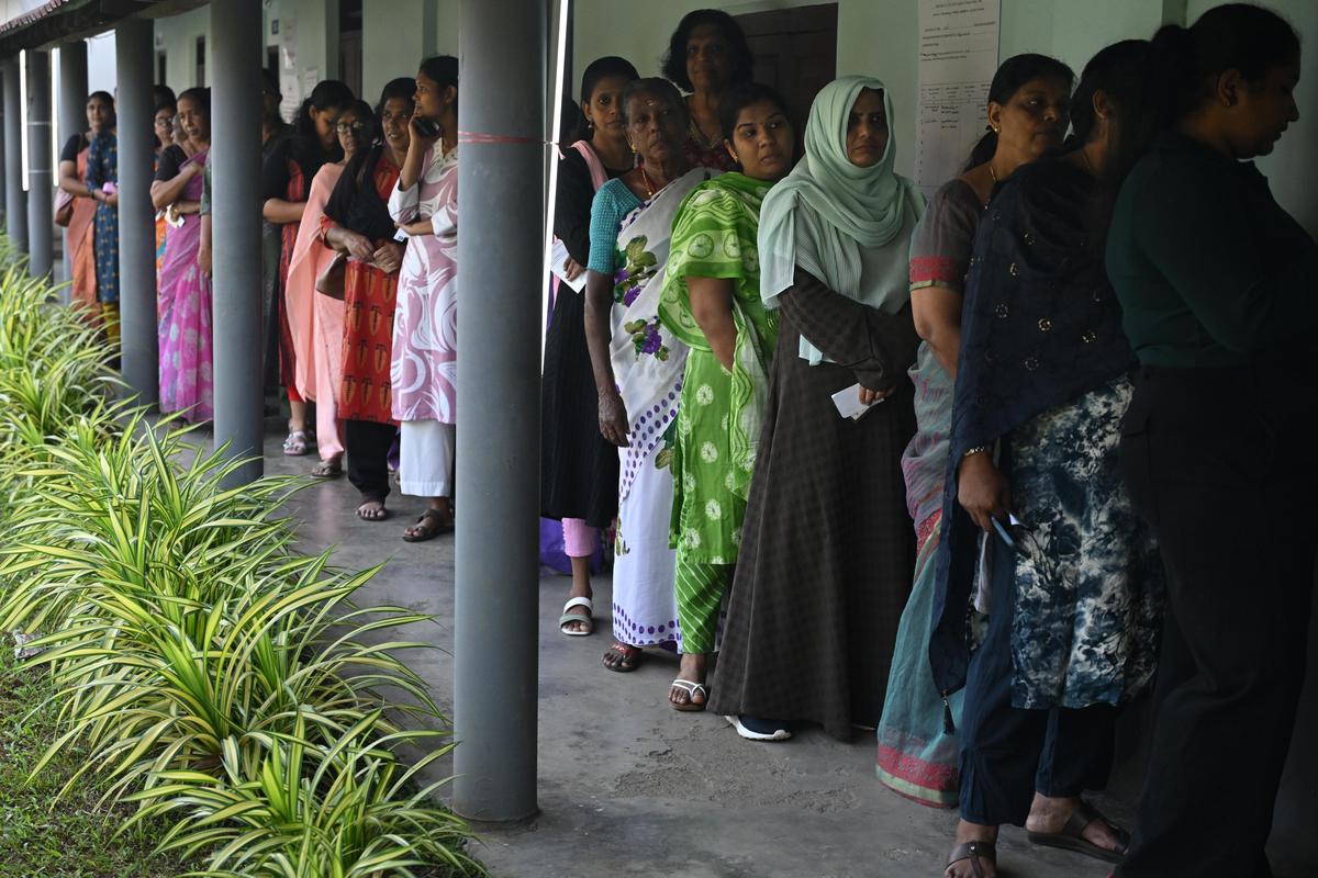 People waiting to cast their vote at a polling booth in Thripunithura on December 9. 