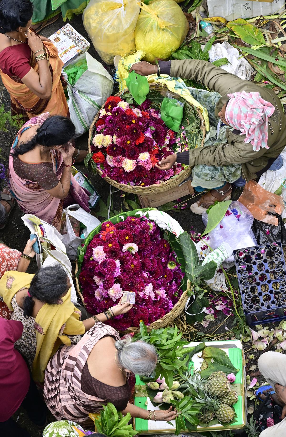 People shopping at K.R. Market in Bengaluru on Wednesday.