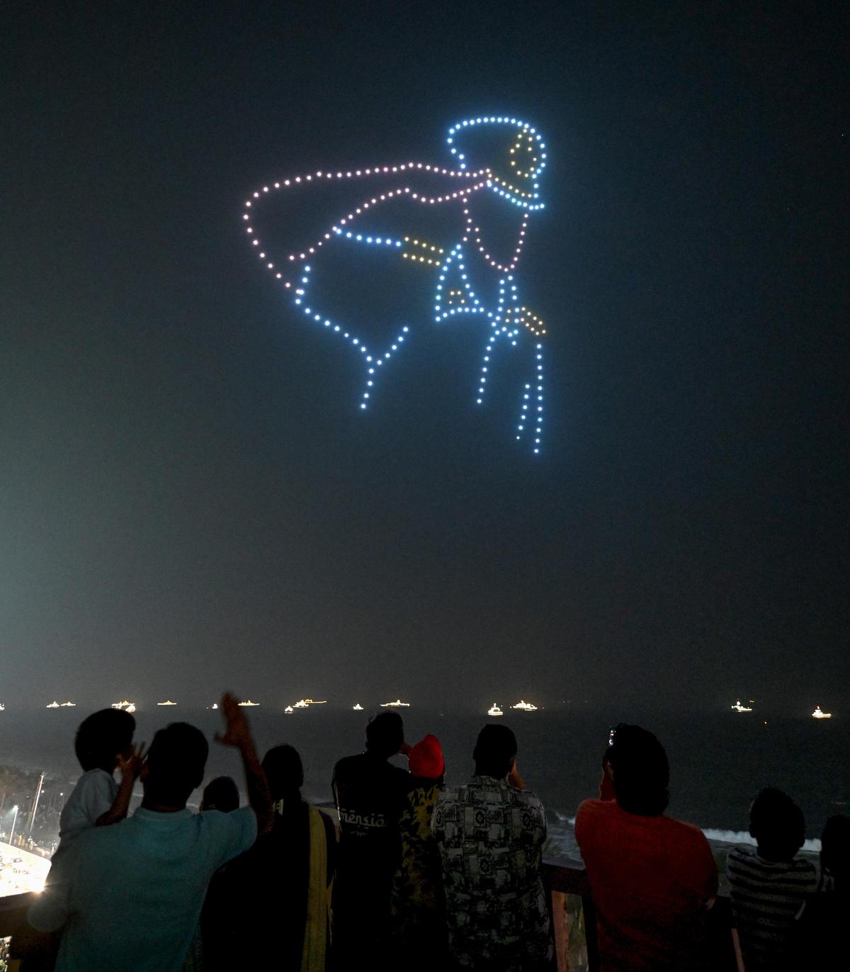 People watch the drone show during 