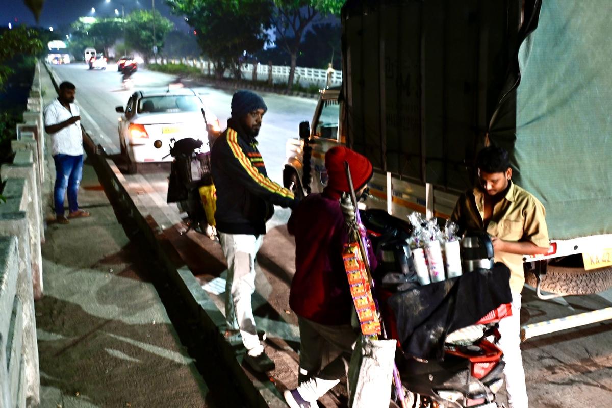 A tea seller serving his customers on a winter morning in Bengaluru.