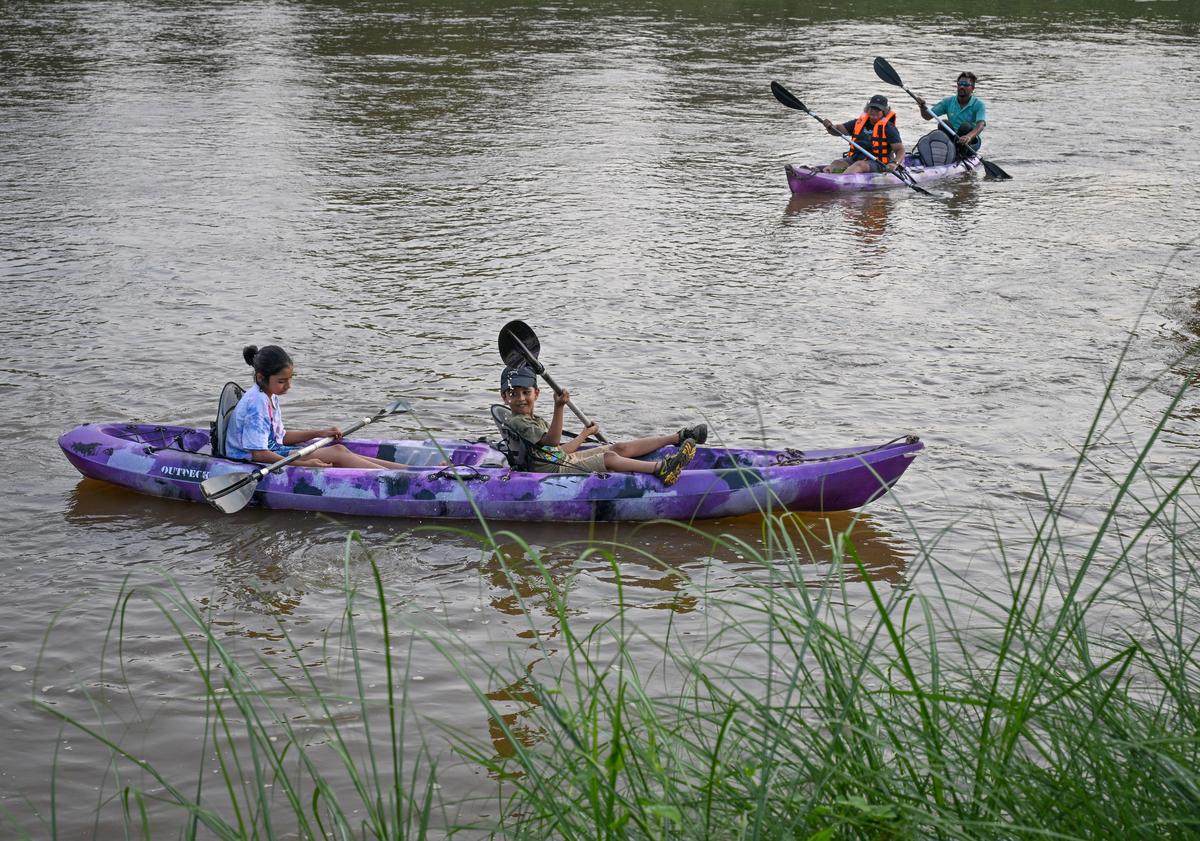 People enjoying kayaking at river Nagavali near Anija at Rayagada in Odisha.