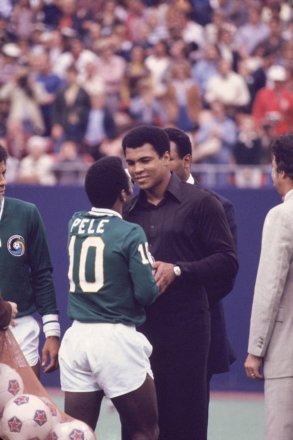 Pele (10) shakes hands with boxer Muhammad Ali before a match at Giants Stadium, New Jersey, USA, 1997. 