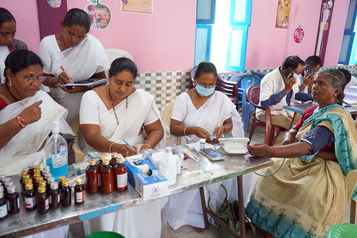 A medical team taking a blood sample from a villager in Turakapalem village near Guntur, following the declaration of a health emergency.