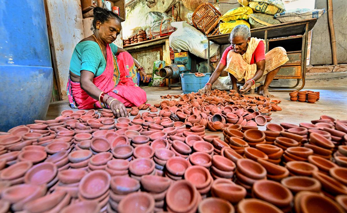 Women segregating dried earthen lamps ahead of Deepavali, at Kummari Veedhi (potters’ street) in Visakhapatnam. Women segregating dried earthen lamps ahead of Deepavali, at Kummari Veedhi (potters’ street) in Visakhapatnam.