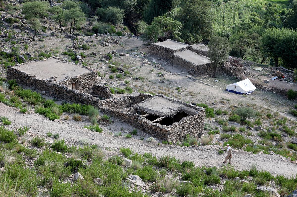 An Afghan man walks next to a damaged house following a deadly earthquake that struck Afghanistan’s Kunar and Nangarhar provinces, in Nurgal district, Kunar province, Afghanistan, on September 4, 2025.
