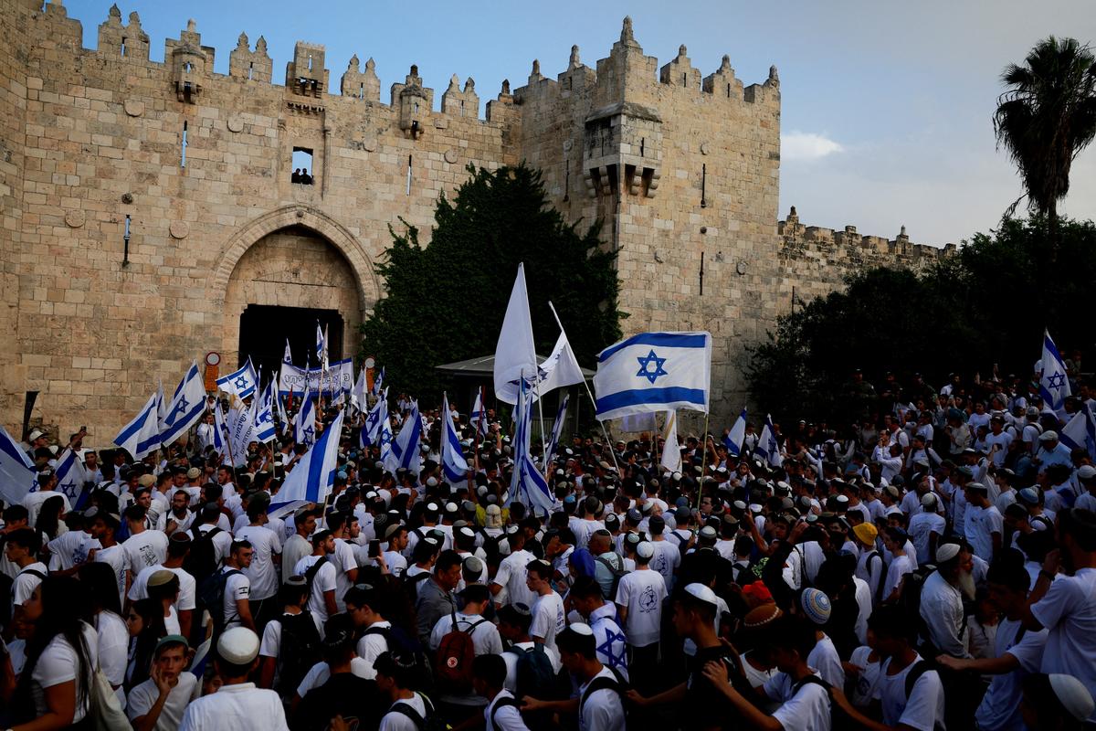 Israelis gather with flags by Damascus Gate to Jerusalem’s Old City, as they mark Jerusalem Day, in Jerusalem, on May 26, 2025.