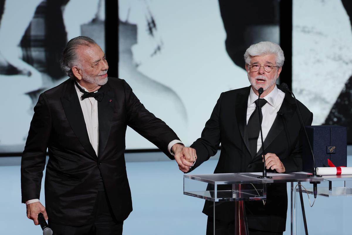 George Lucas (R) receives the Honorary Palme D’Or Award presented by Francis Ford Coppola (L) during the Closing Ceremony at the 77th annual Cannes Film Festival at Palais des Festivals on May 25, 2024, in Cannes, France.