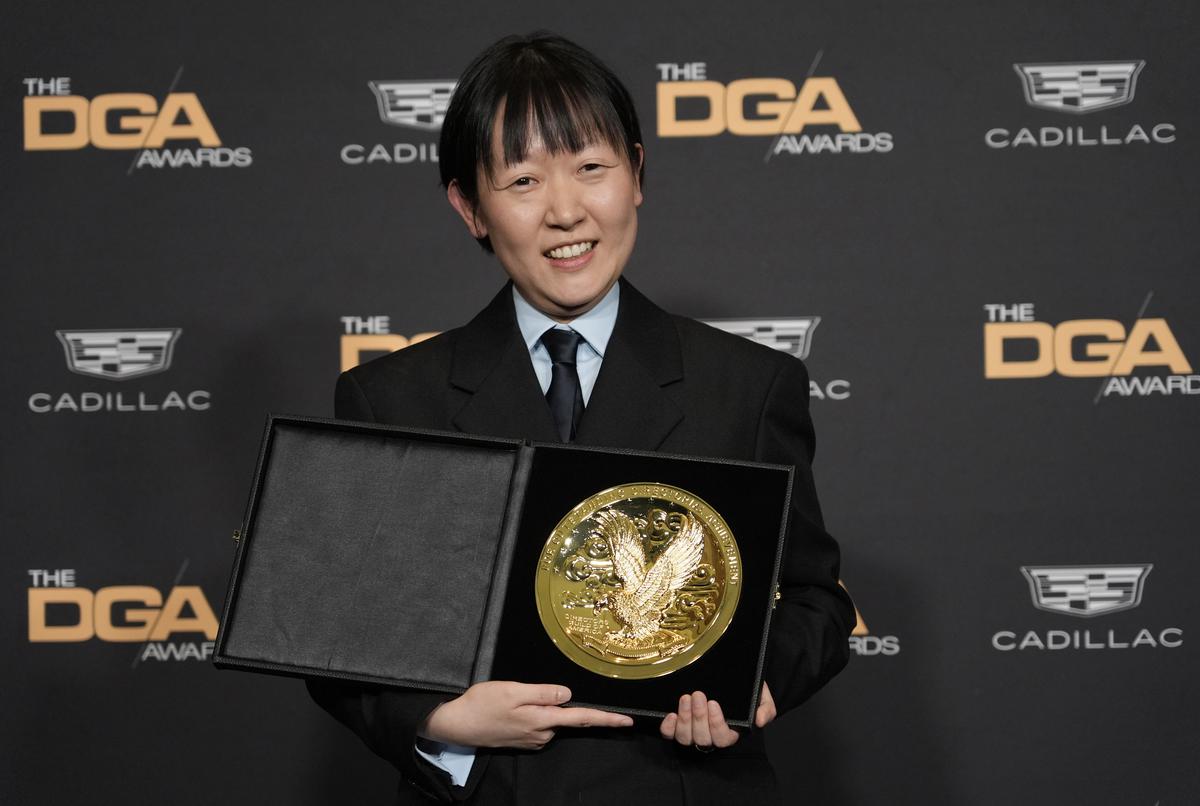 Celine Song, director of the film ‘Past Lives,’ poses with the Michael Apted First-Time Theatrical Feature Film Director Award at the 76th DGA Awards