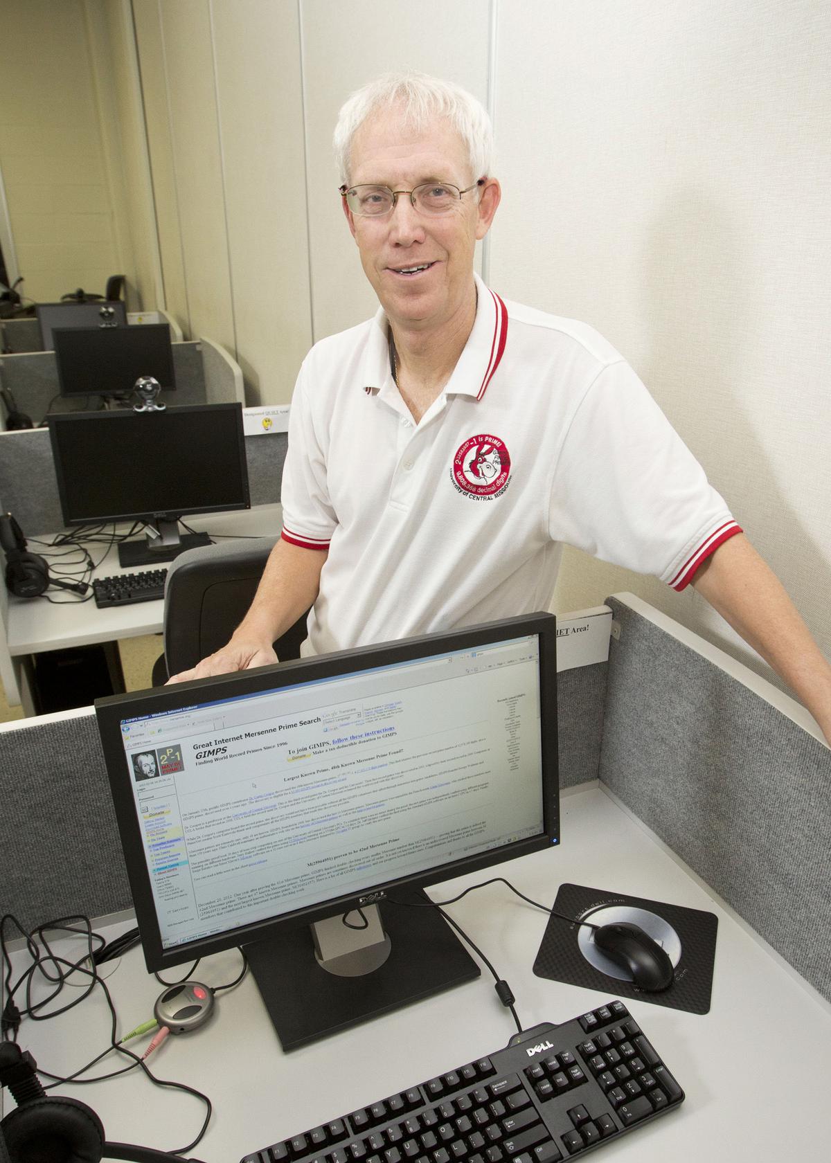 This photo provided by the University of Central Missouri shows computer science and mathematics professor Curtis Cooper. A group led by Cooper found the 48th known Mersenne prime in January 2013.  You can see the monitor in the picture having information about GIMPS.