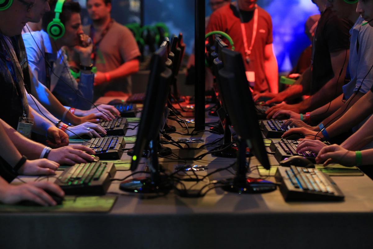 Gamers use desktop computer keyboards at the Gamescom video games trade fair in Cologne, Germany
