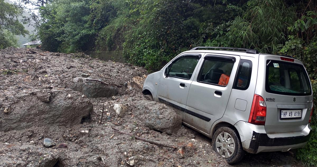 A vehicle got stuck in debris following a cloudburst at Horn Guard village, in Kullu on June 25, 2025. A vehicle got stuck in debris following a cloudburst at Horn Guard village, in Kullu on June 25, 2025.