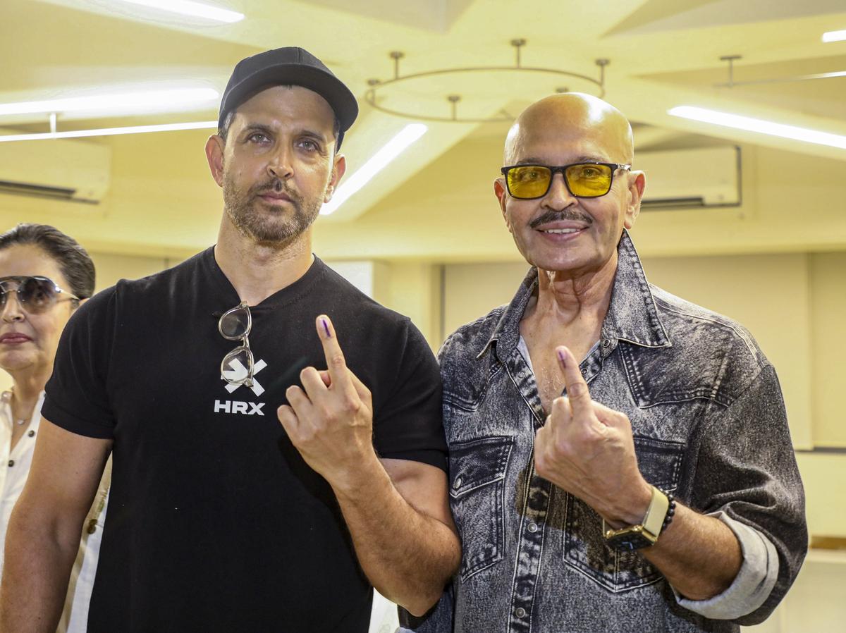 Mumbai: Actors Rakesh Roshan and Hrithik Roshan show their inked fingers after casting their vote during the fifth phase of Lok Sabha elections in Mumbai on Monday, May 20, 2024. 