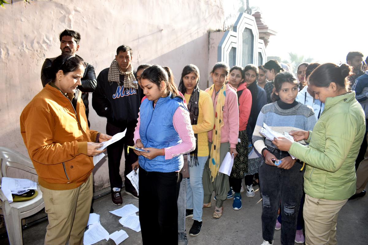 Candidates arrive at an examination centre in Meerut to appear for the U.P. police constable recruitment exam.