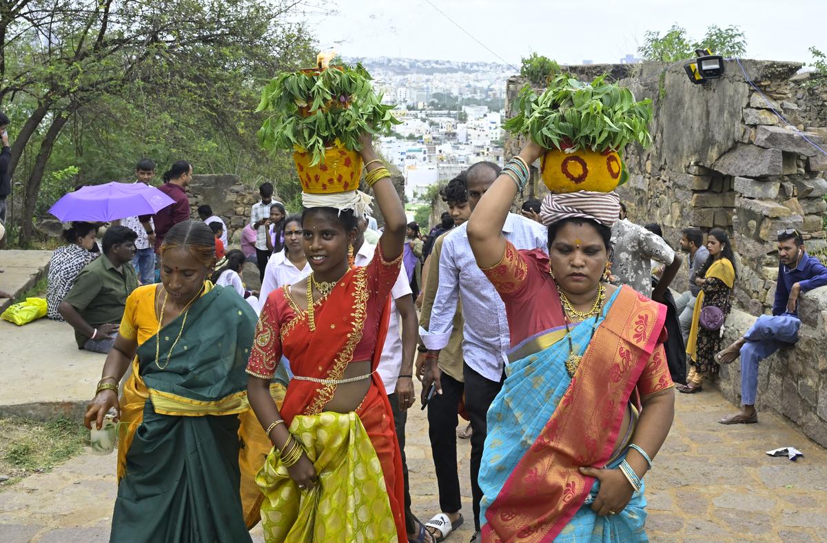 Devotees carry ‘Bonam’ during the Bonalu festival at Golconda Fort. 
