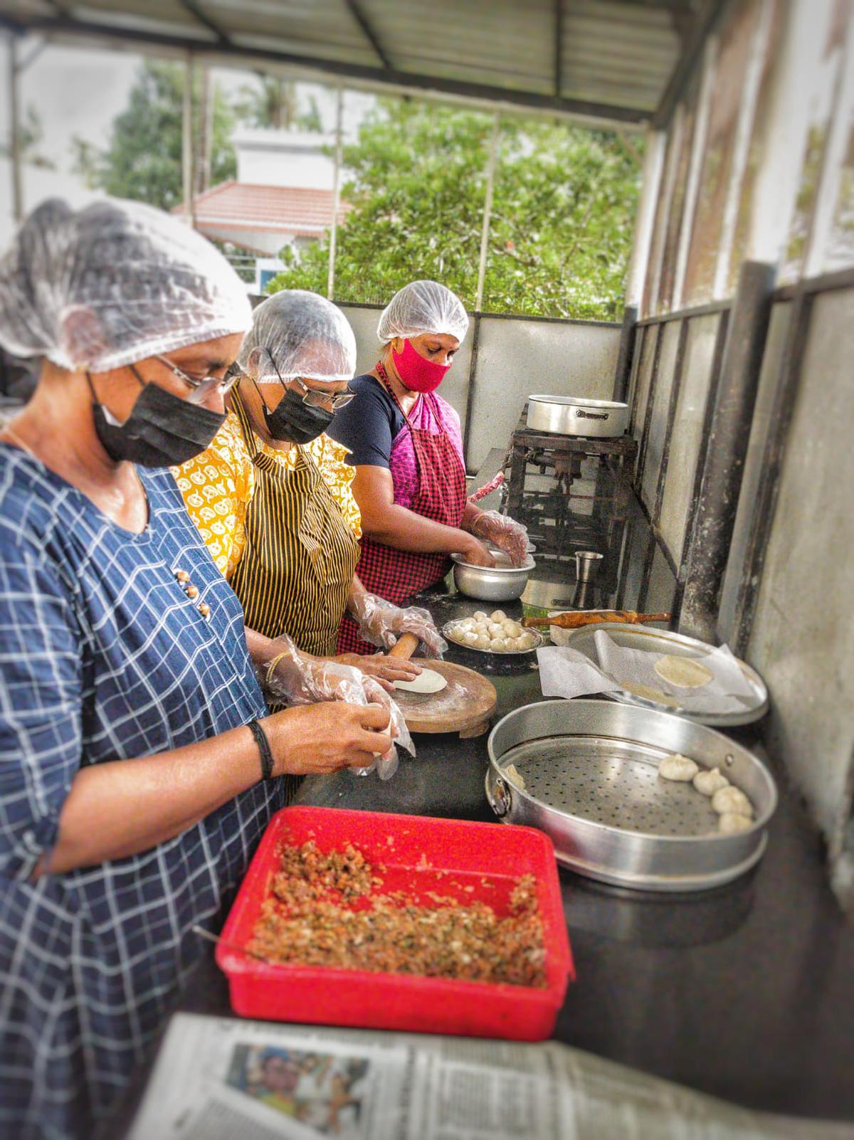 Girija S, Jayalakshmi T and Shobha S making momos at Burger Band’s central kitchen