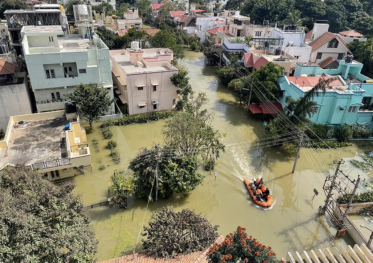 Fire personnel evacuate the residents of Rainbow Layout after the Halanayakanahalli Lake breach following heavy rains, on Sarjapur road, Bengaluru, September 5, 2022.