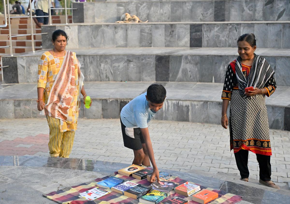 A child checks out books at Lake Reads, a silent reading session by the Chitlapakkam Lake 