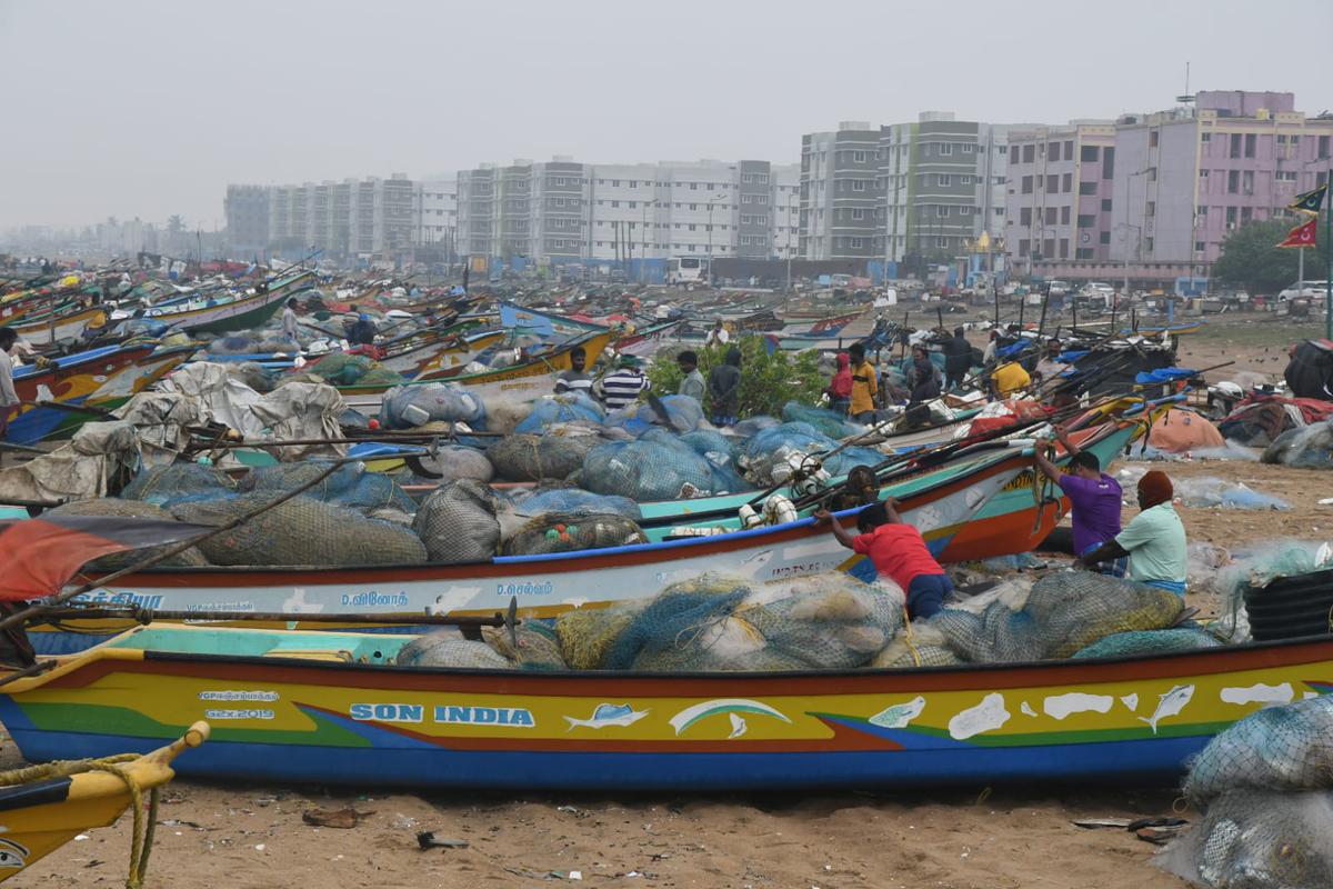 With the boats anchored on the shores due to Cyclone Mandous, fishermen got some break to do their routine work like net sorting in Chennai on December 9, 2022.