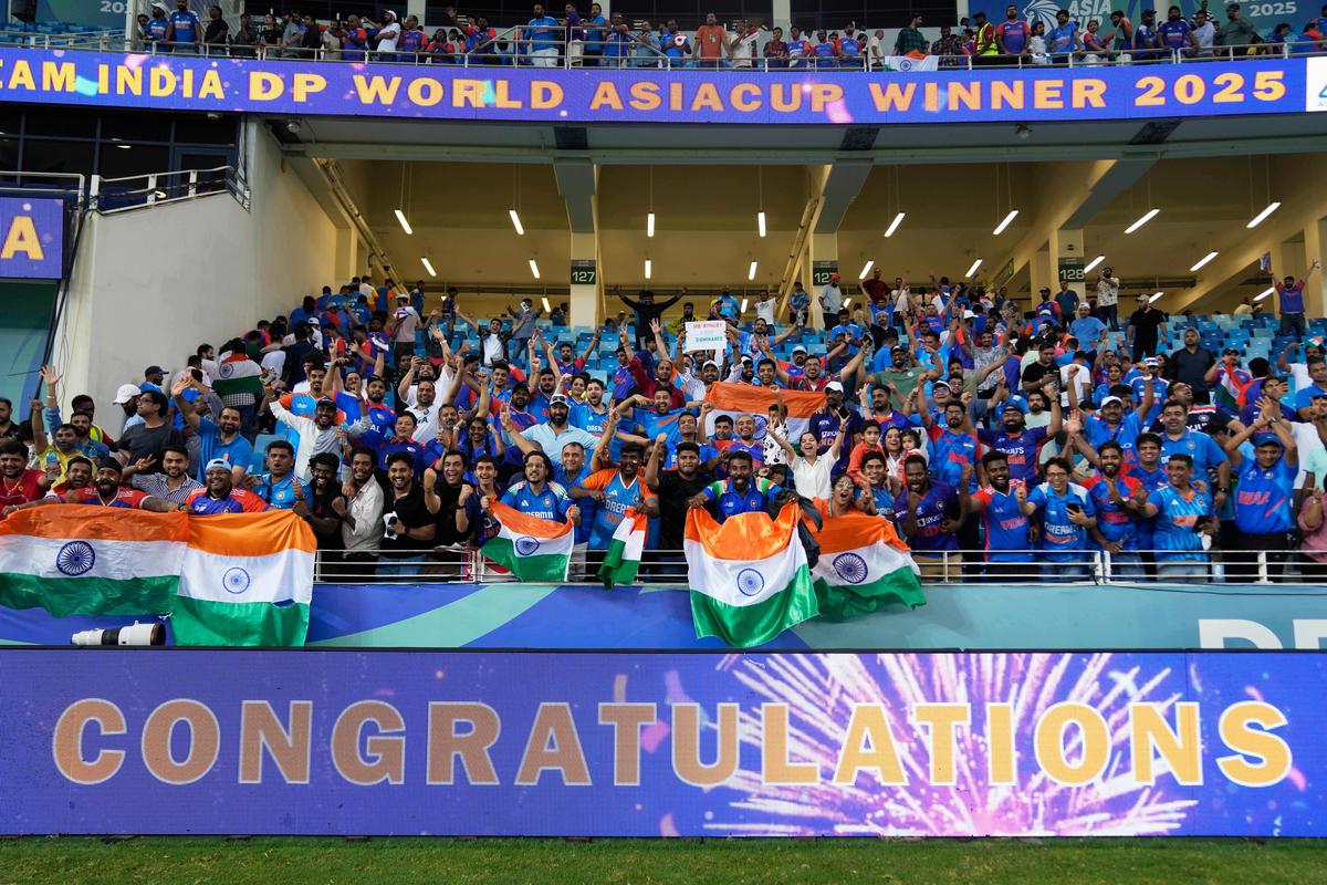 Fans celebrate after India won the Asia Cup cricket final against Pakistan at Dubai International Cricket Stadium, United Arab Emirates, on September 28, 2025.