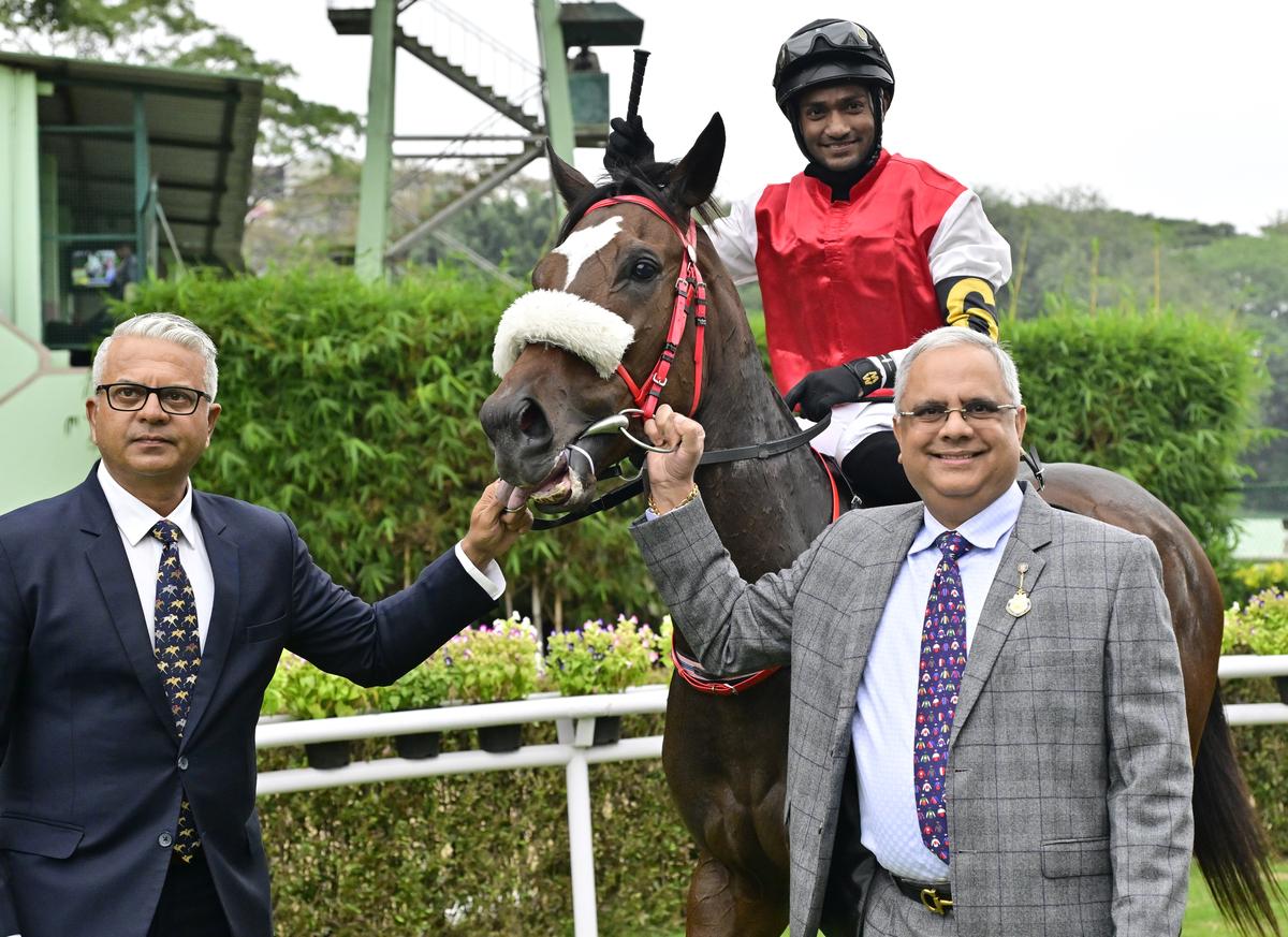 Owner Chaduranga Kanthraj Urs, right, and trainer S.S. Attaollahi leading in Regal Reality (jockey Akshay Kumar, up) after winning The Bangalore 1000 Guineas, at the Bangalore Turf Club (BTC), in Bengaluru on November 30, 2024.    