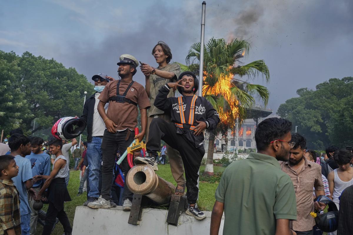 Protesters at the Singha Durbar, the seat of the Nepal government’s various ministries and offices, after it was set on fire. Protesters at the Singha Durbar, the seat of the Nepal government’s various ministries and offices, after it was set on fire.