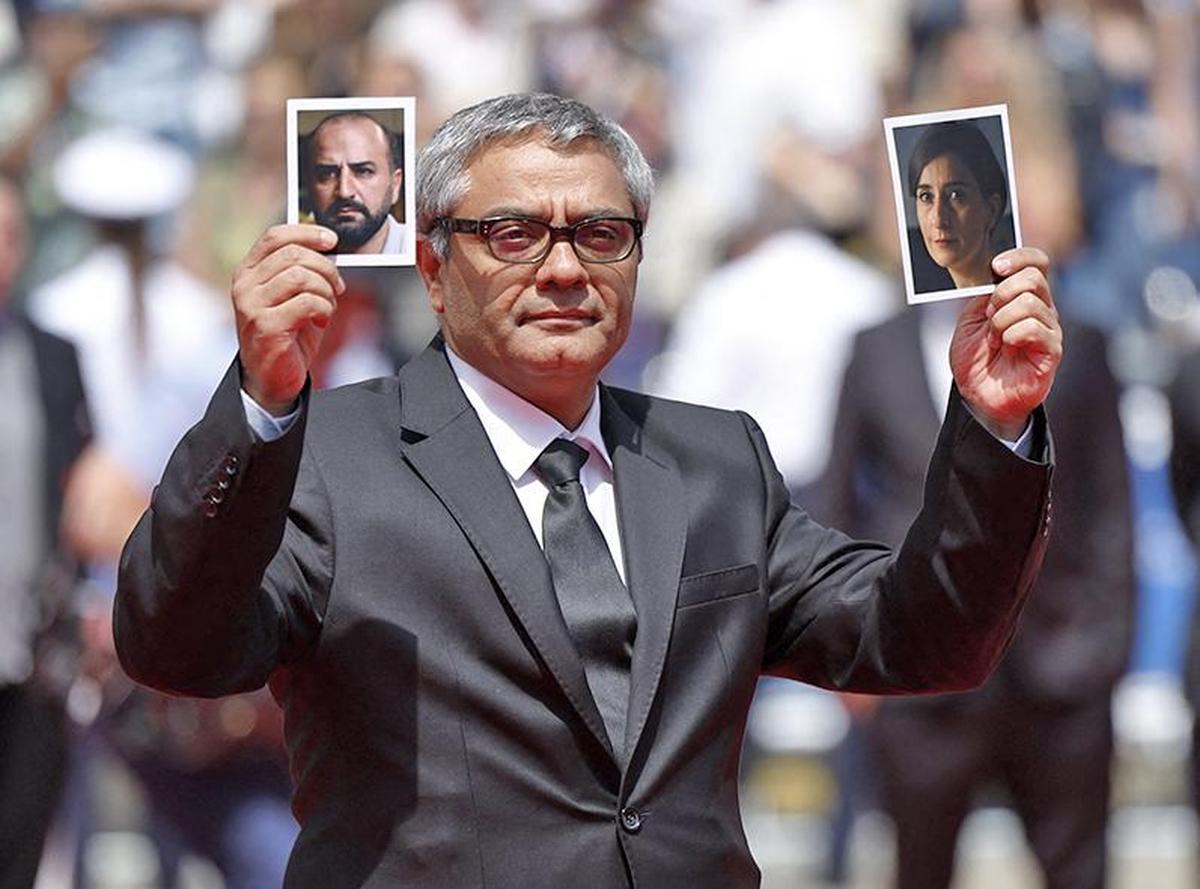 Director Mohammad Rasoulof holds pictures of cast members Missagh Zareh and Soheila Golestani before the screening of The Seed of the Sacred Fig Director Mohammad Rasoulof holds pictures of cast members Missagh Zareh and Soheila Golestani before the screening of The Seed of the Sacred Fig