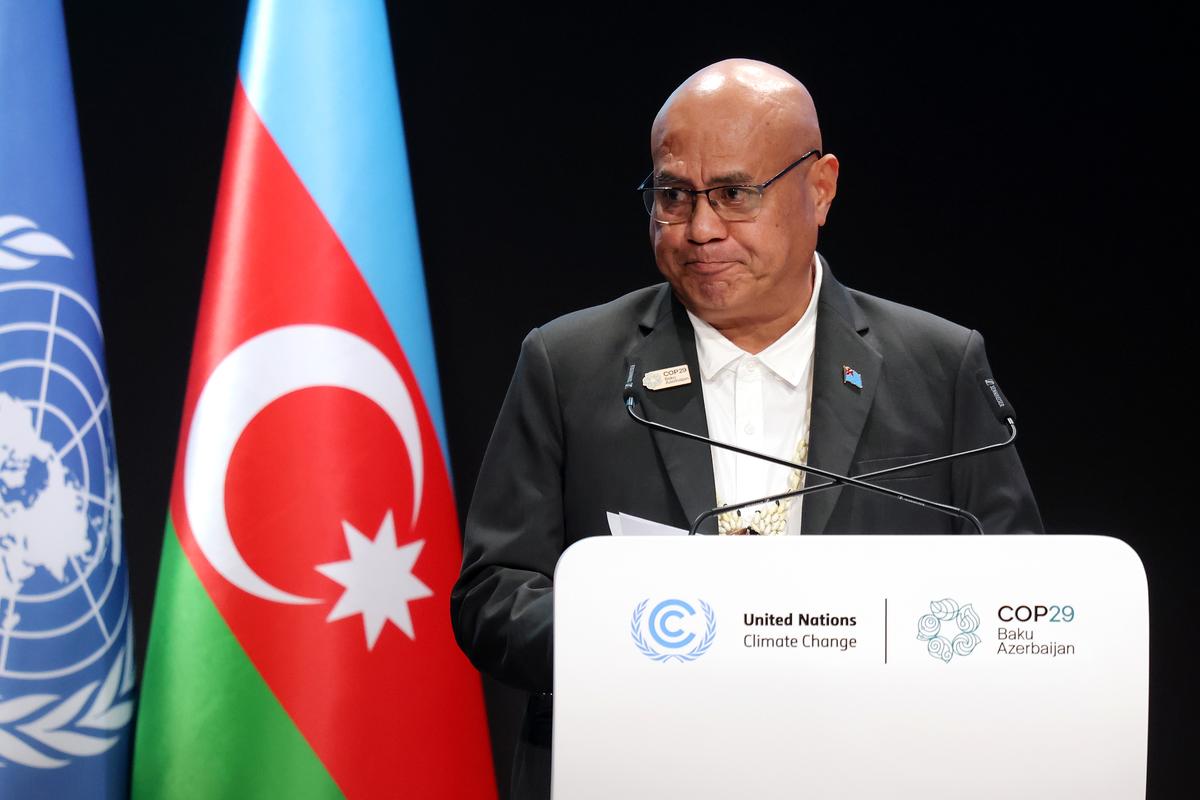 Tuvaluan Prime Minister Feleti Penitala Teo reacts after delivering a national statement during the high level segment on day three of the UNFCCC COP29 Climate Conference at Baku Stadium on November 13, 2024 in Baku, Azerbaijan. 