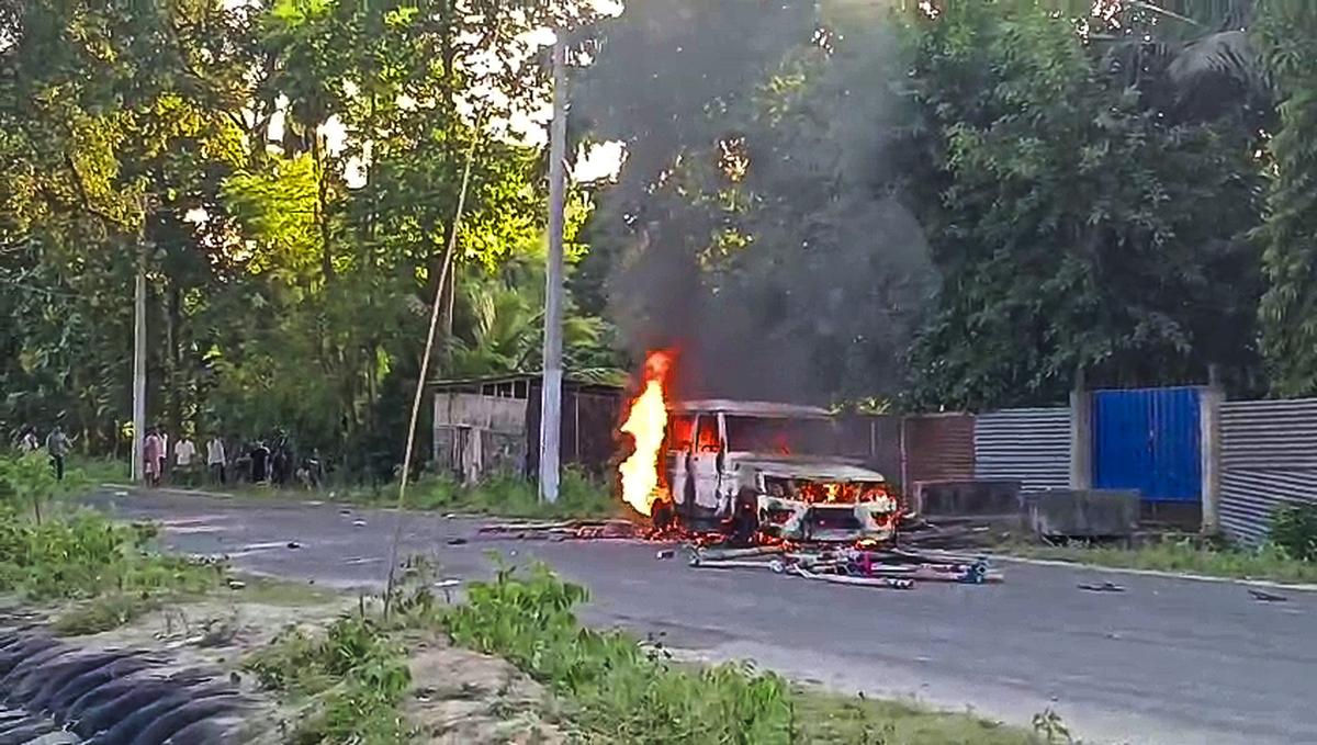 Protesters set a vehicle on fire during their protest, in Guwahati on October 15, 2025. (Videograb)