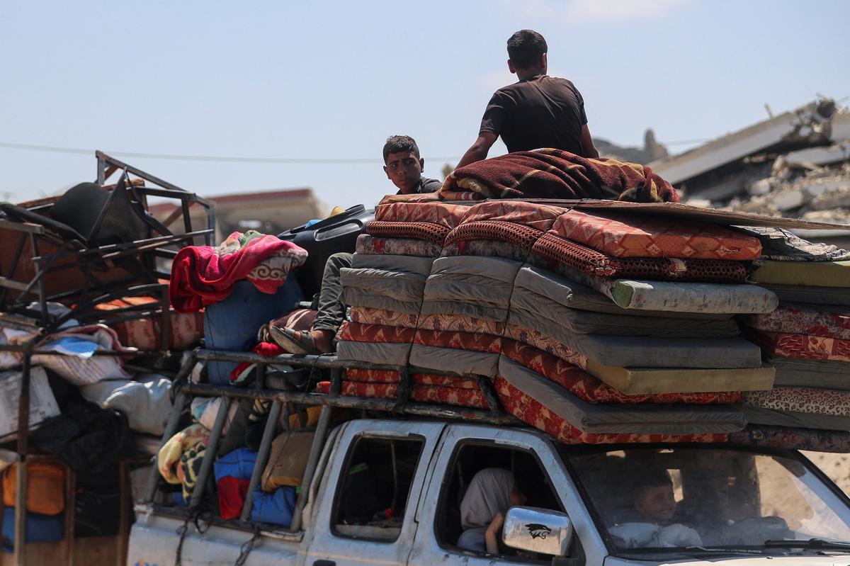 Displaced Palestinians fleeing northern Gaza travel in a vehicle loaded with their belongings while they head south as the Israeli military prepares to relocate residents to the southern part of the enclave, in Gaza City, August 18, 2025. 