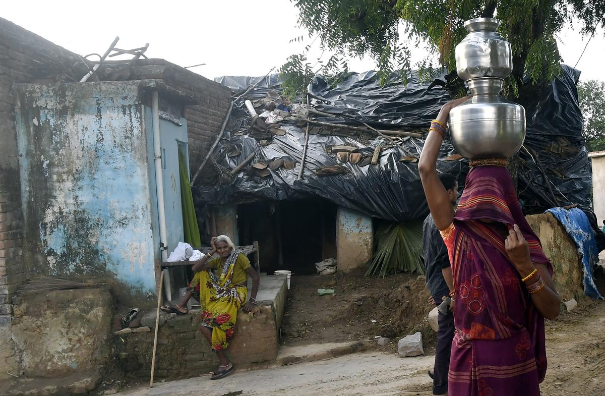 A resident carrying drinking water, from a Water Treament Plant, as household tap connections provided under Har Ghar Jal scheme as part of Jal Jeevan Mission, at Gorkha Village in Charkhari Block of Mahoba district in Uttar Pradesh, in the Bundelkhand region.