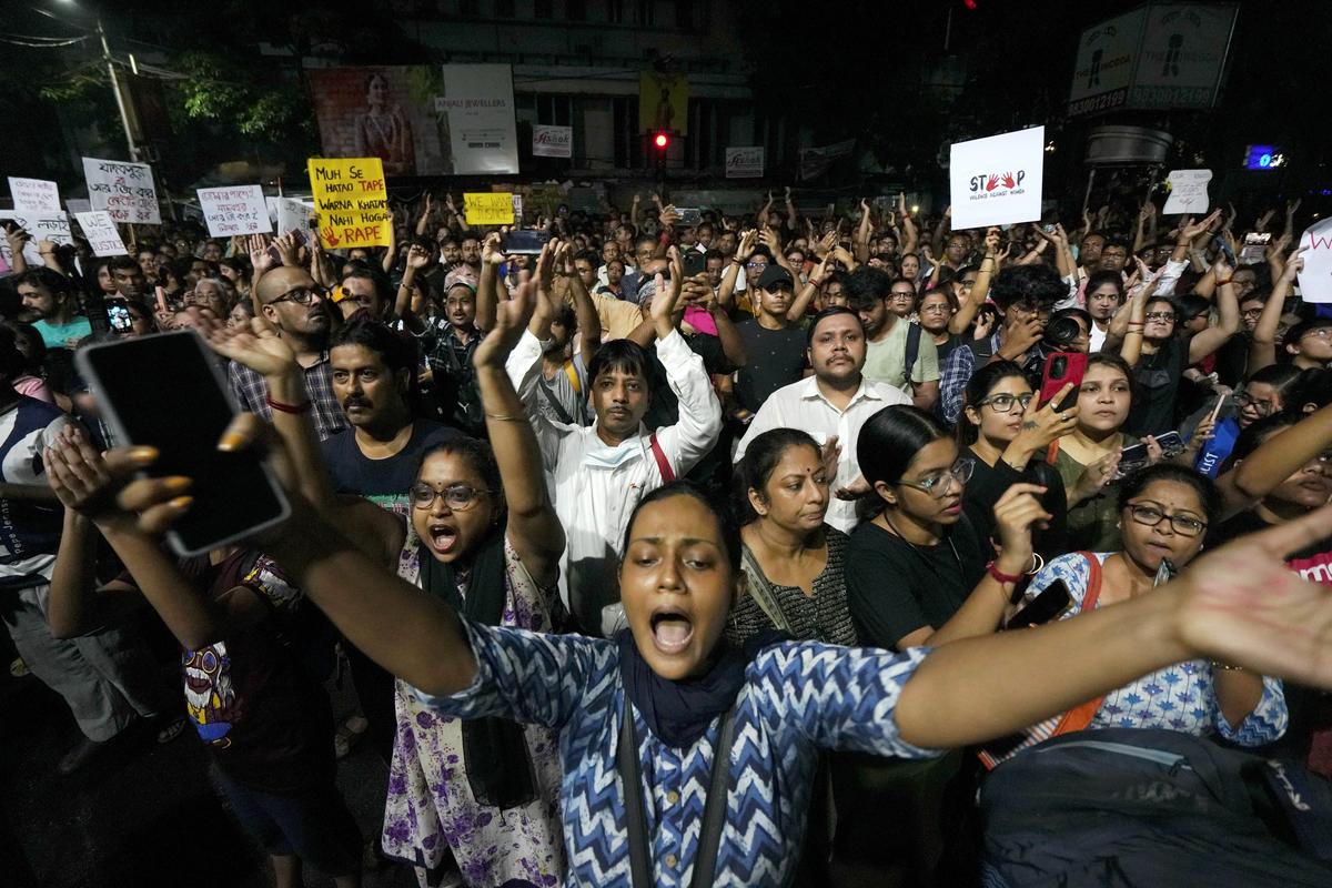 People gather at Jadavpur at midnight on the eve of Independence Day to protest against the rape and killing of a trainee doctor at the RG Kar Medical College, in Kolkata on August 14, 2024. 