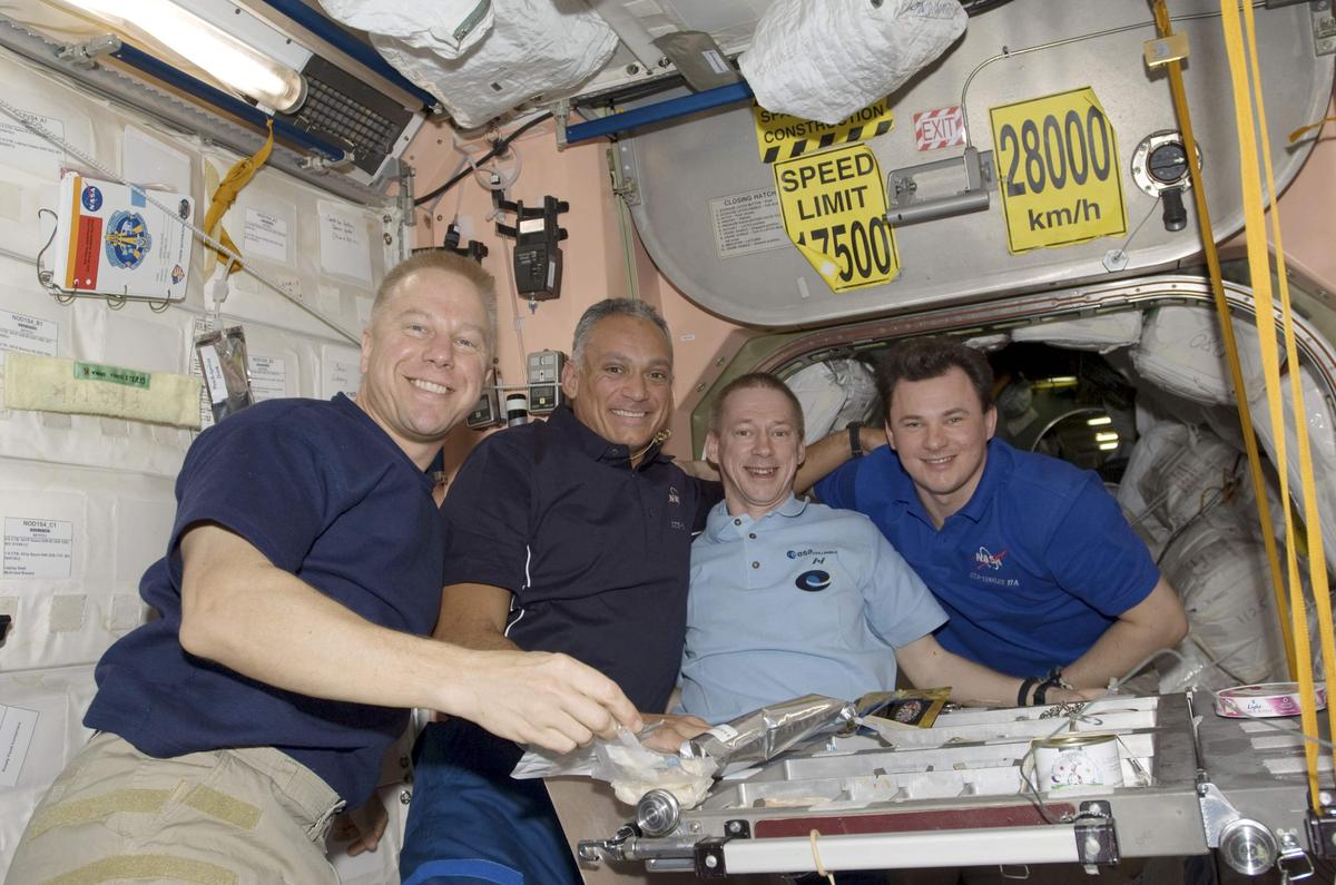 (From left to right) Astronauts Tim Kopra, John “Danny” Olivas, Frank De Winne and Roman Romanenko pose for a photo in the Unity node of the International Space Station in this NASA handout photo taken on September 7, 2009.   