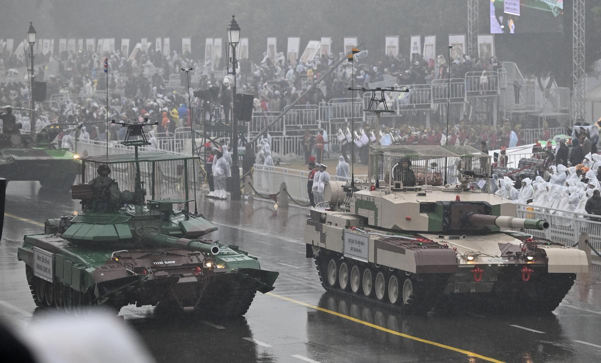 Indian Army 'Bhishma' T-90 Tank, left, and MBT Arjun MK-I Tank proceed amid rainfall and coldest day during the full dress rehearsal for the upcoming 77th Republic Day Parade celebrations, at Kartavya Path in New Delhi, Friday. January 23, 2026. 