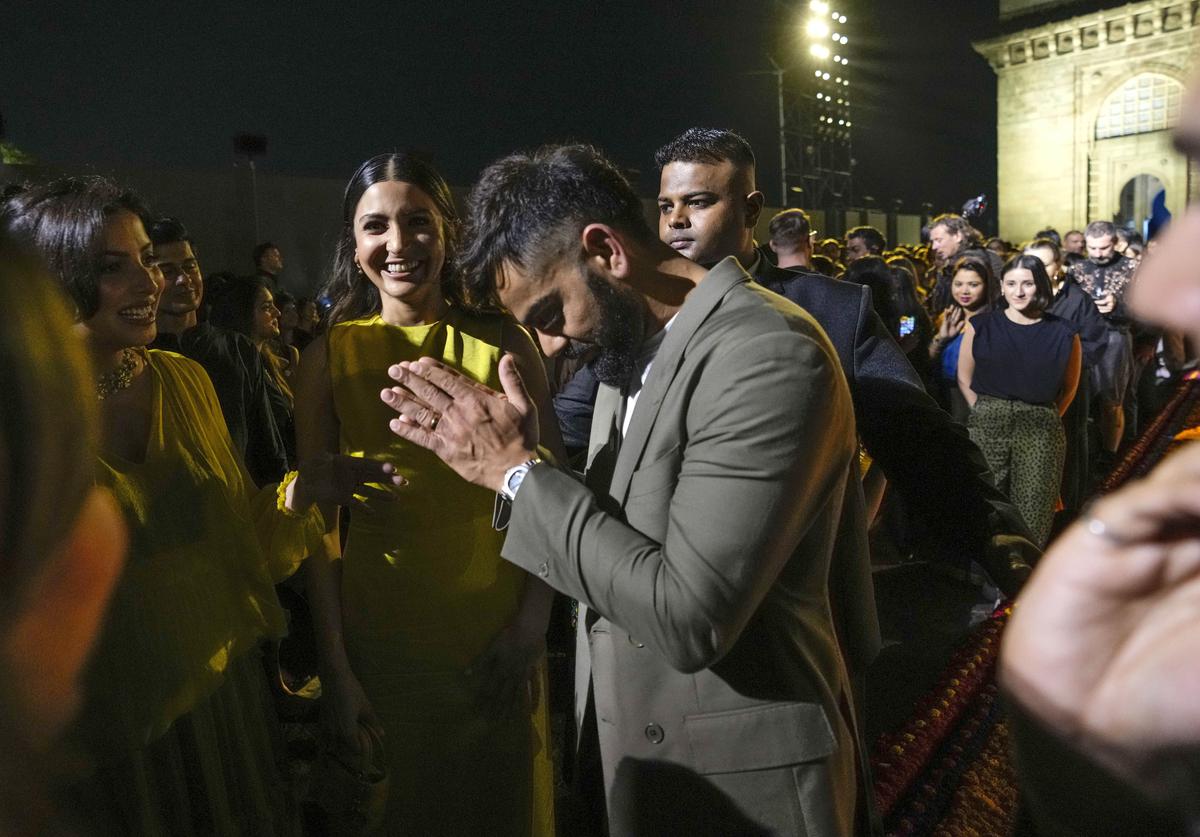 Indian cricketer Virat Kohli leaves with his wife Anushka Sharma at the end of the Dior Pre-Fall 2023 collection at the Gateway of India.