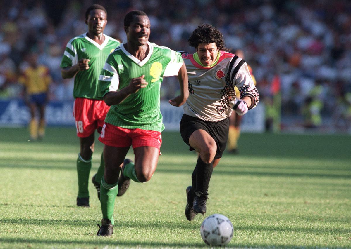 Forward Roger Milla from Cameroon runs past Colombian goalkeeper Jose Higuita (R) after stealing the ball from him on his way to score a goal on June 23, 1990 in Naples during the World Cup second round match between Cameroon and Colombia. Milla scored two goals in extra time