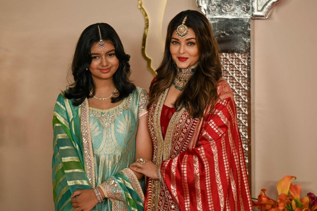 Bollywood actress Aishwarya Rai Bachchan (R) poses with her daughter Aaradhya as they arrive to attend the wedding ceremony of Anant Ambani (son of billionaire tycoon and Chairman of Reliance Industries Mukesh Ambani) and Radhika Merchant in Mumbai, on July 12, 2024 Bollywood actress Aishwarya Rai Bachchan (R) poses with her daughter Aaradhya as they arrive to attend the wedding ceremony of Anant Ambani (son of billionaire tycoon and Chairman of Reliance Industries Mukesh Ambani) and Radhika Merchant in Mumbai, on July 12, 2024