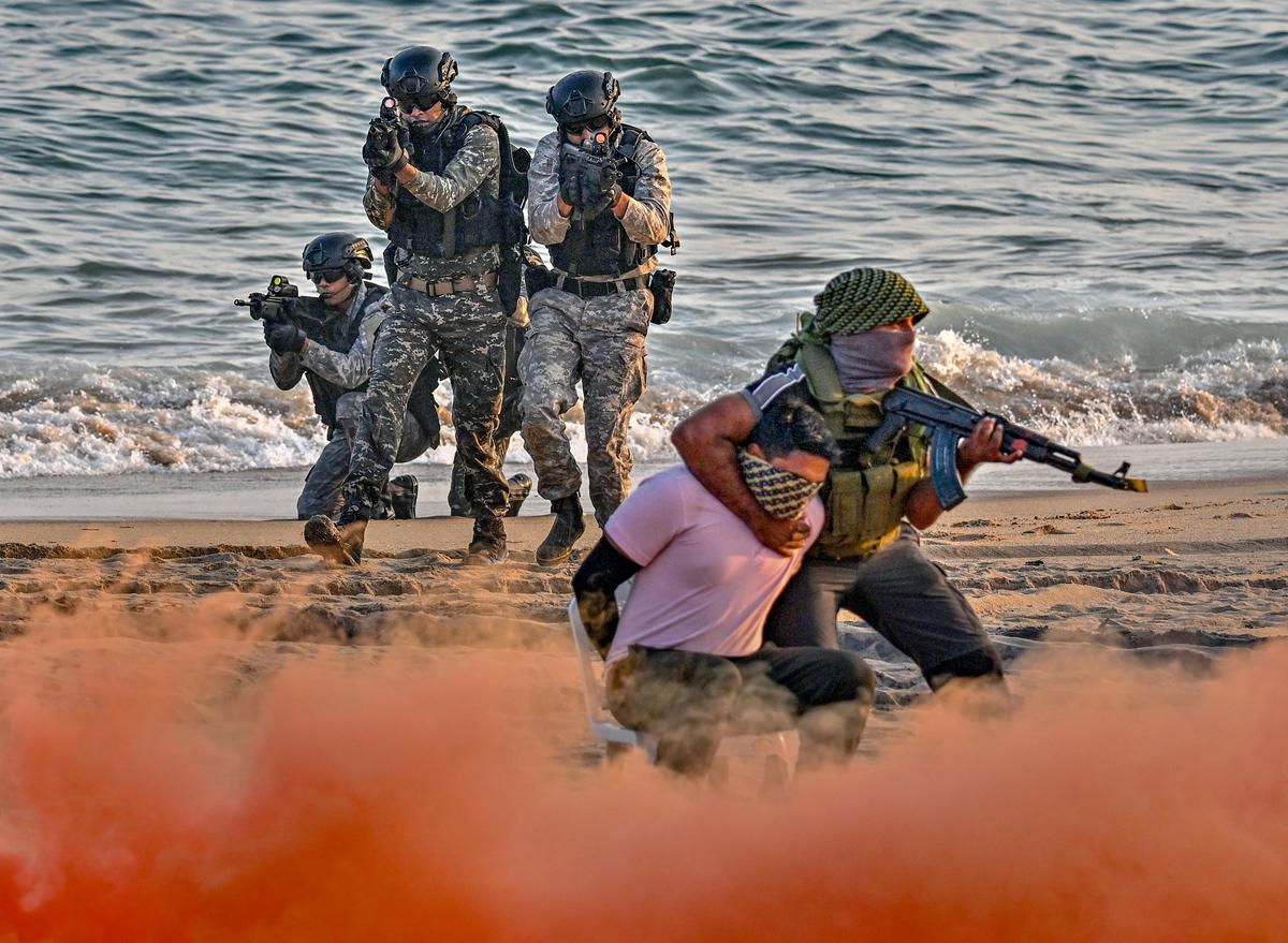 Marcos (Marine Commandos) of Indian Navy simulating a beach assault  off the coast of Visakhapatnam near RK Beach during the rehearsals for the Operational Demonstration of Indian Navy.