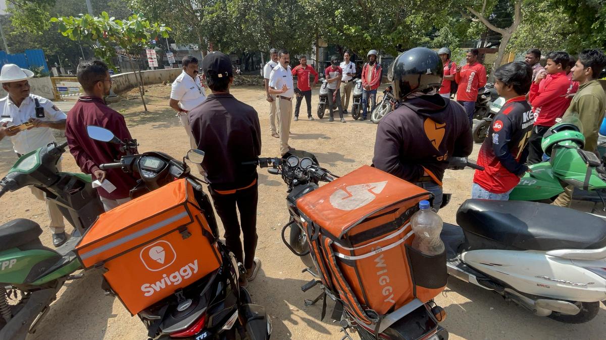 Traffic Police officials educate the gig workers employed by Food delivery service about various traffic violations and to obey traffic rules, in Bengaluru. The police have warned aggregators that they will now begin fixing accountability directly on the companies through existing laws if violations continued.
