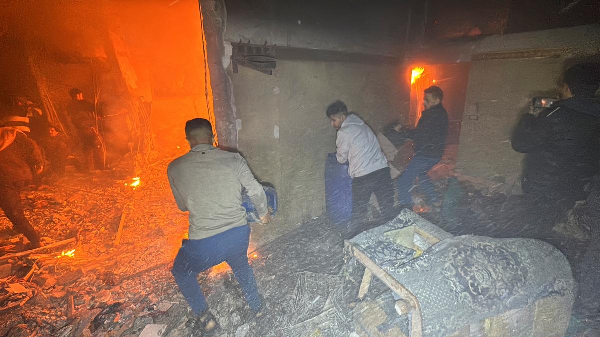 Palestinians try to extinguish a fire inside a house near Kamal Adwan hospital, during the ongoing Israeli military operation, amid Israel-Hamas conflict, in Beit Lahiya, in the northern Gaza Strip, December 17, 2024. 