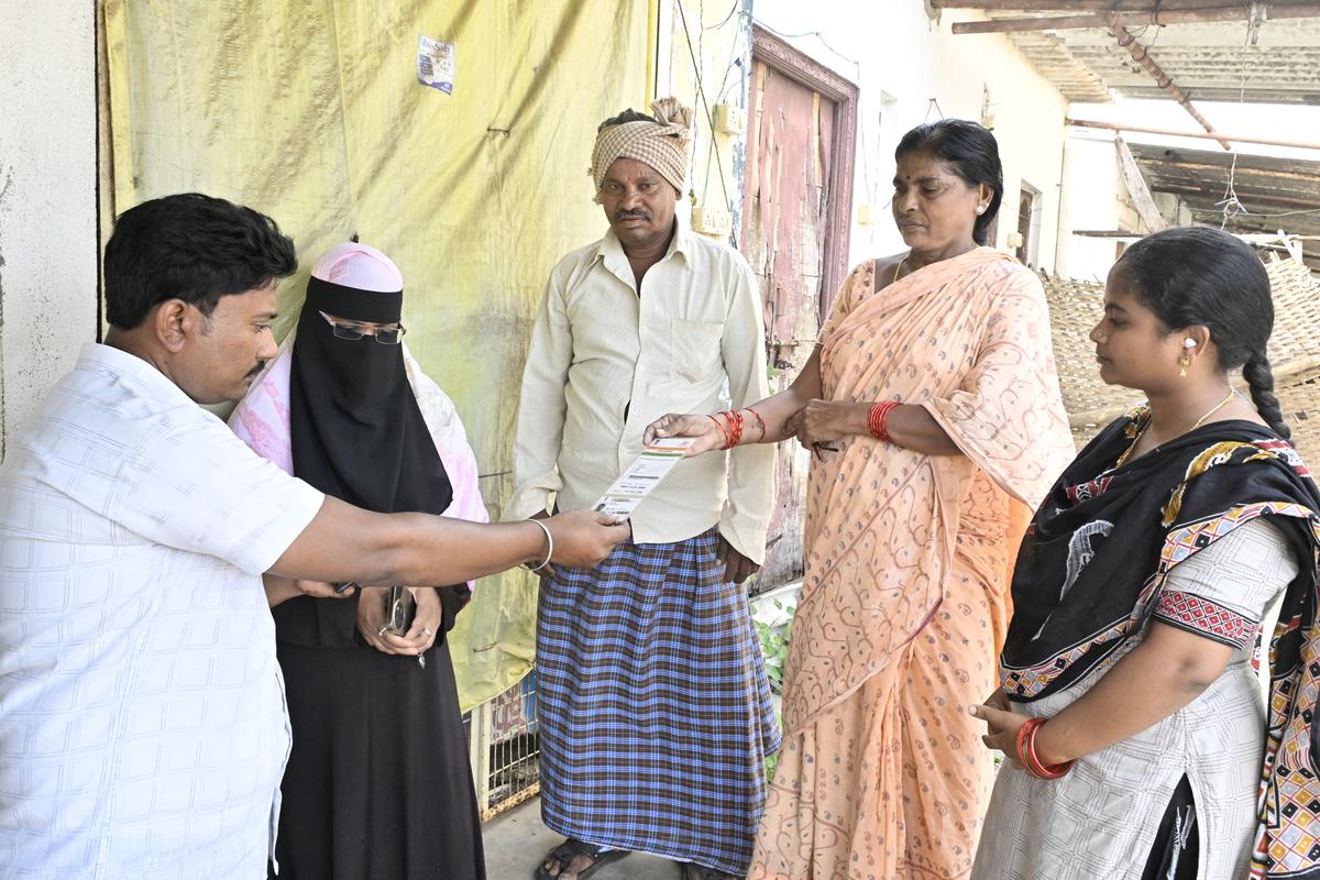 Sachivalayam staff interacting with Katikam Bhiksham and his wife Narayanamma, locals of Penumaka village.