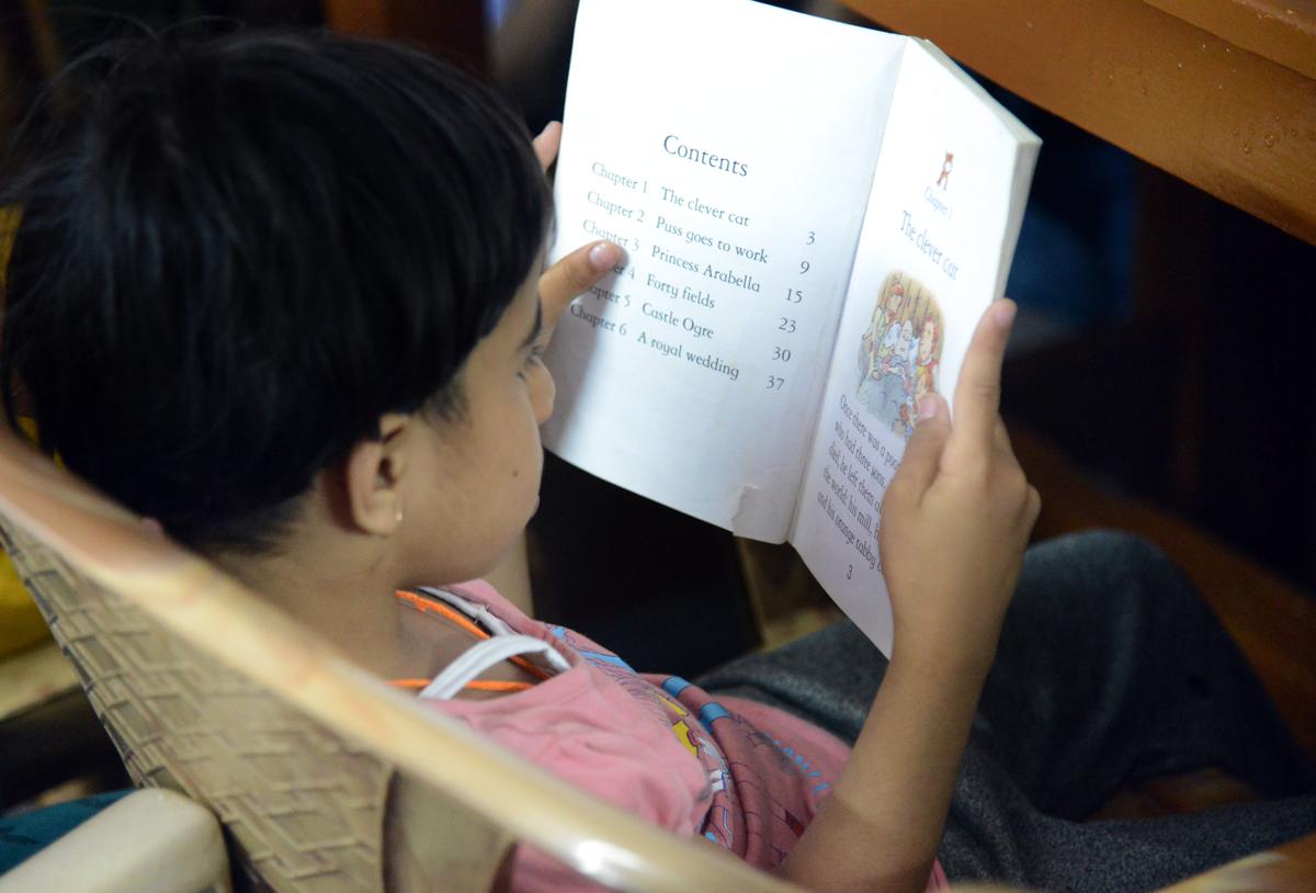 Physically challenged children at a reading session at Library of Cheshire Homes India-caring for disabled girls and elderly women on Old Airport Road. 