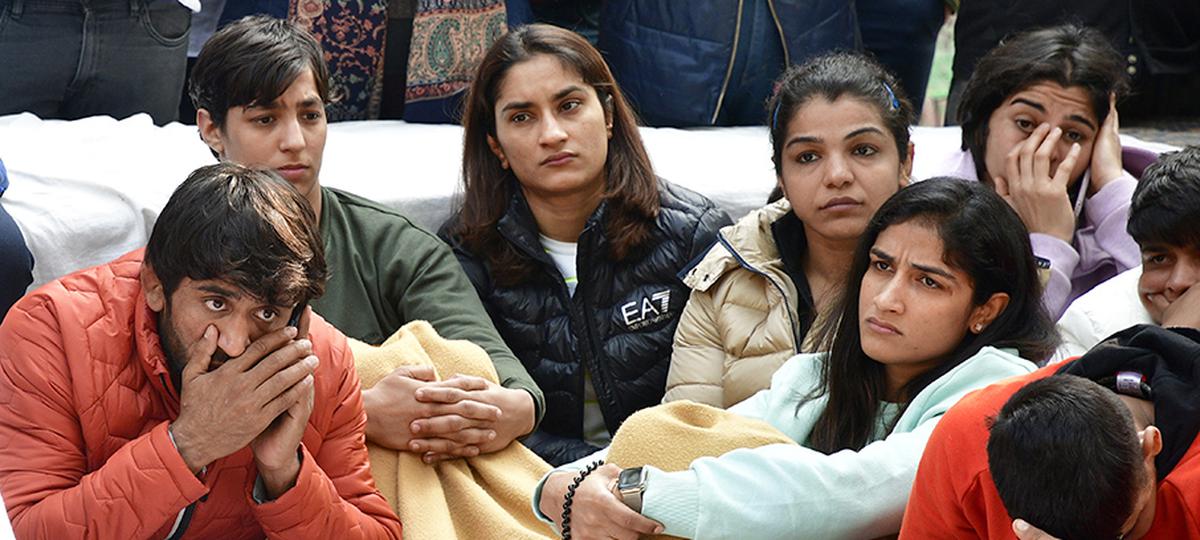 Khushi’s sporting hero Vinesh Phogat (centre) sits with Sakshi Malik and other wrestlers at the demonstration at Jantar Mantar in New Delhi.