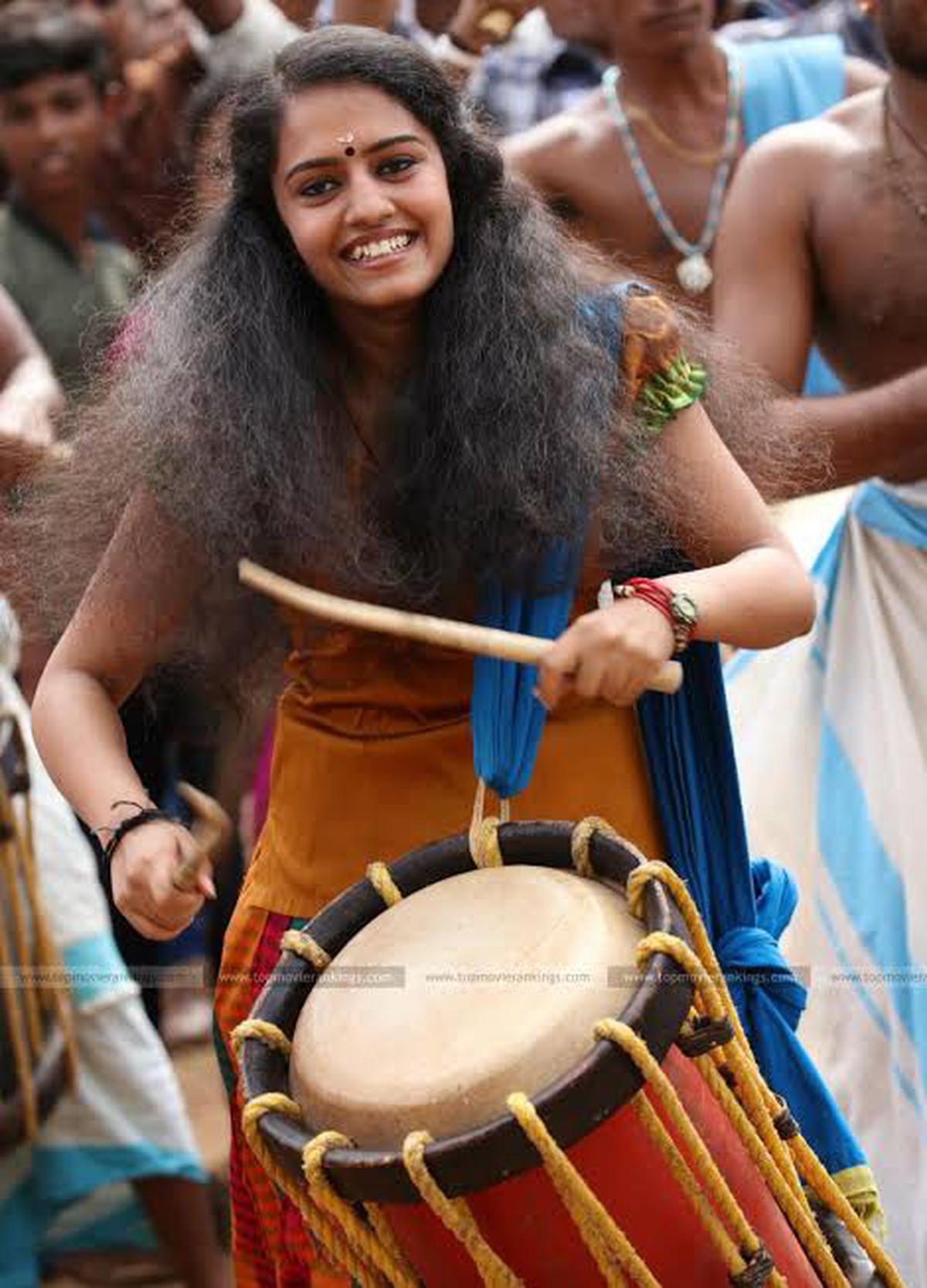 Shilpa Sreekumar playing the chenda in a scene from Kuttanpillayude Sivarathri