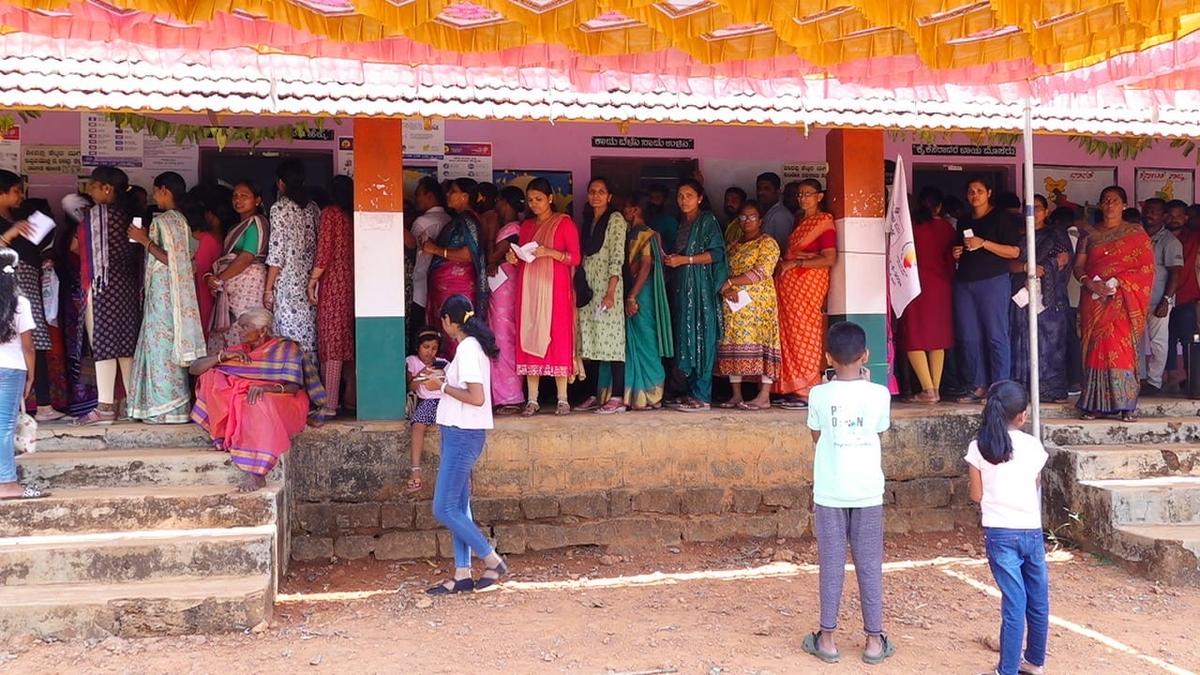 People waiting to vote at polling station 139 at Government Higher Primary School, Sulugodu, under Hallihole village, in Udupi on Tuesday. The village is a Maoist-affected area. 