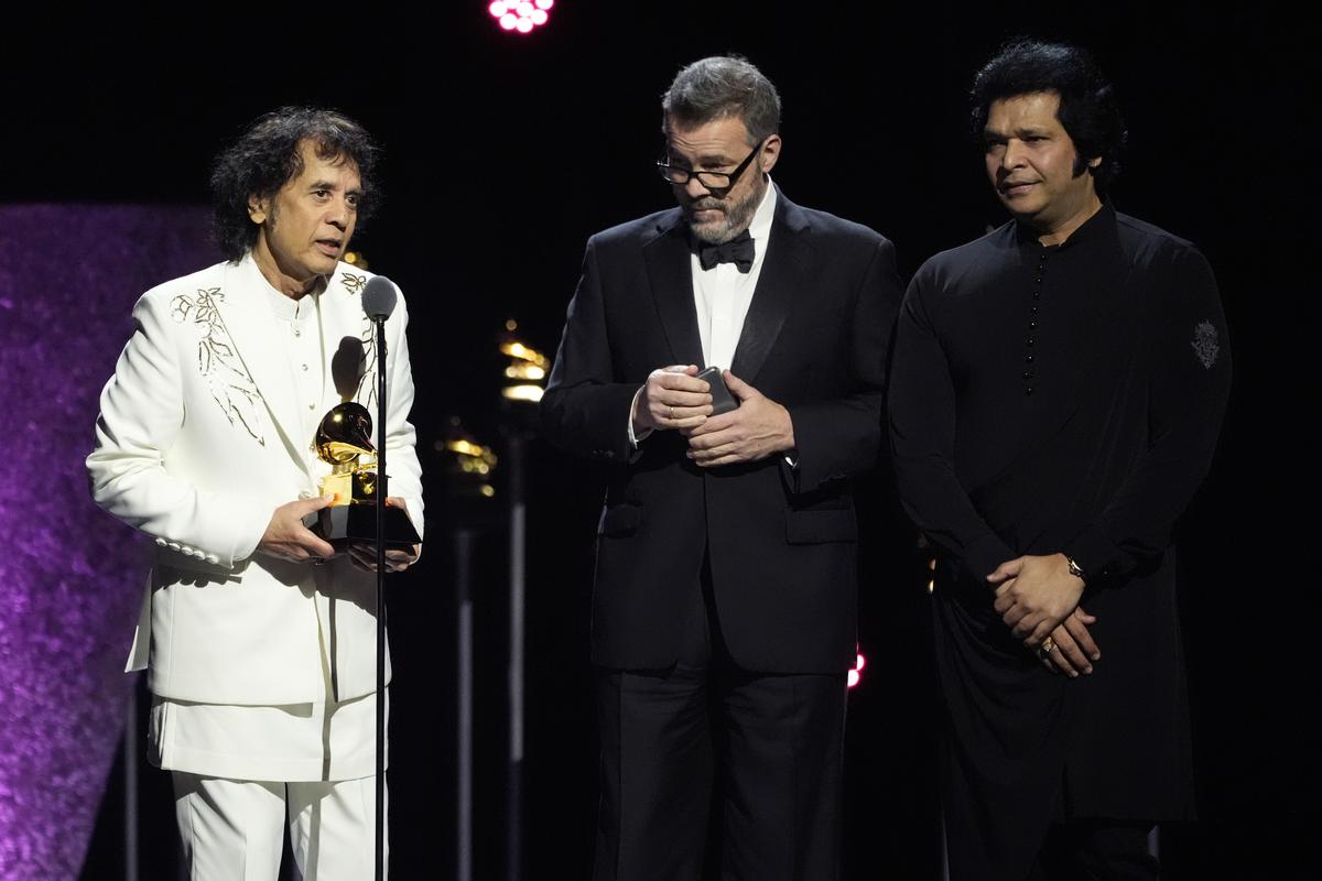 Zakir Hussain, from left, Edgar Meyer and Rakesh Chaurasia accept the award for best global music performance for ‘Pashto’ during the 66th annual Grammy Awards 